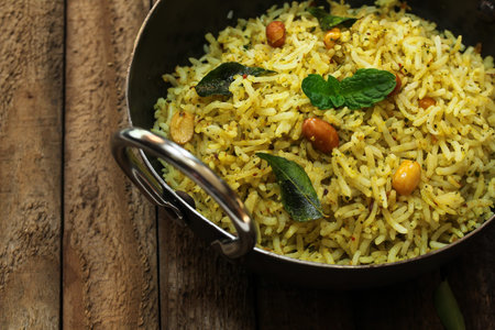 South Indian Curry leaves rice / Karuvepilai sadam served in a Kadai
