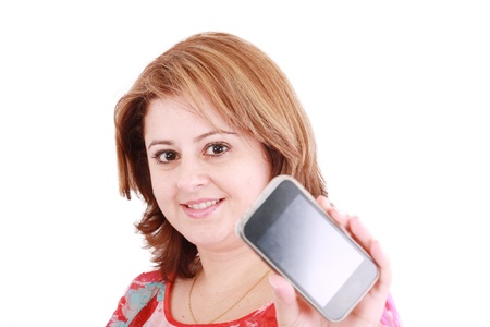Portrait of a confident young woman showing mobile phone against white backgroundの写真素材