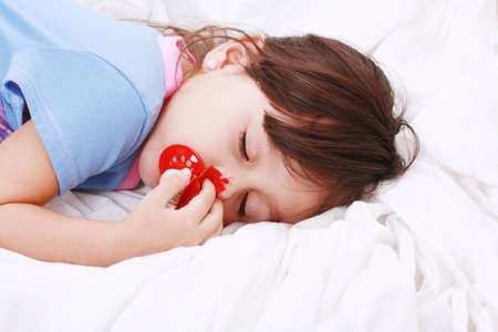 sweet happy little girl sleepingの写真素材