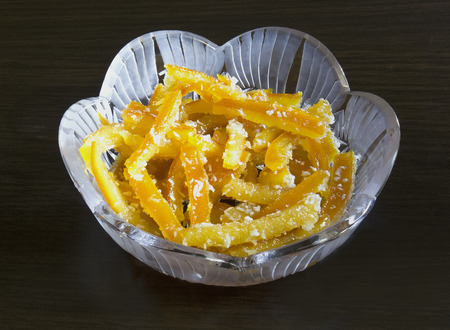 Orange candied fruits in a crystal vaseの写真素材