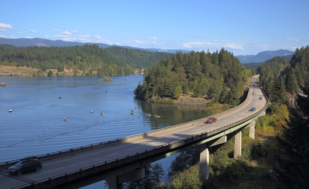 Beautiful view of road, mountains, trees and riverの写真素材
