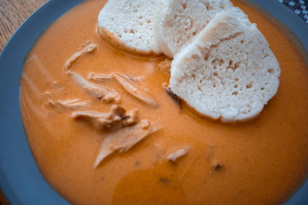 Traditional chicken hen on paprika or paprica creamy sauce with bread dumlings, typical czech food
