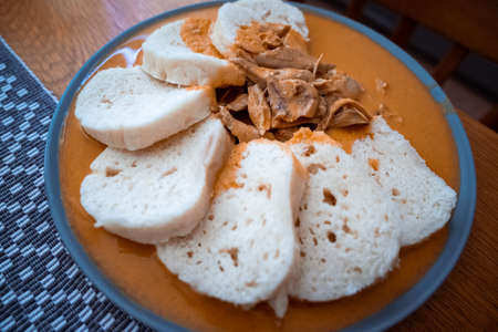 Traditional chicken hen on paprika or paprica creamy sauce with bread dumlings, typical czech foodの写真素材