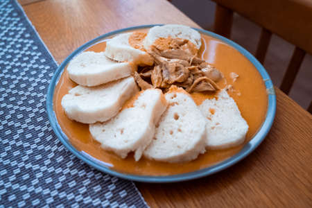 Traditional chicken hen on paprika or paprica creamy sauce with bread dumlings, typical czech foodの写真素材
