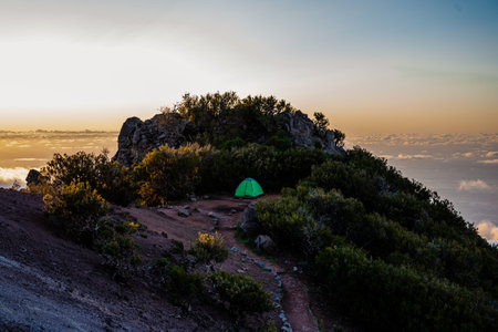 Camping into mountains from the Pico de Ariero to Pico Ruivo. Madeira, Portugal, tent on the topの写真素材