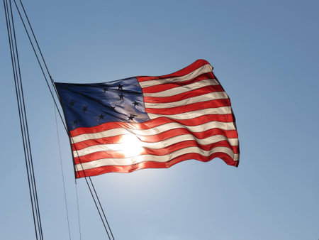 American Flag waving in front of sunの写真素材
