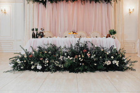 Elegant wedding presidium the restaurant decorated with flowers, evergreens, roses, orchids in pleasant pink and beige tonesの写真素材