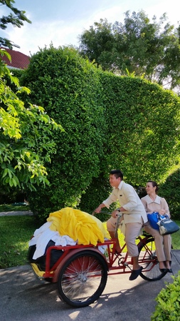 two hotel staff cycling along the hotel path with happy faceのeditorial素材