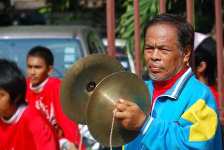 The old instrument play castanets Manipulation in the parade dragon.  The Vegetarian Festival 2010, Chiangmai, Thailandのeditorial素材