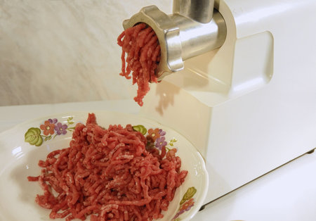 preparing mince with electrical meat grinder