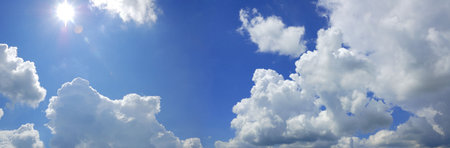 blue cloudy sky with sun panorama