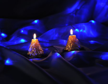 gold candles on blue glow backgroundの写真素材