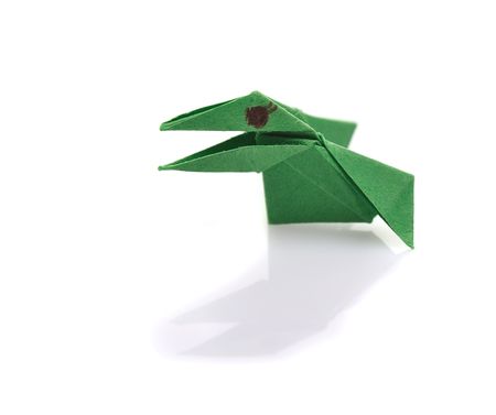 green raven of tiny  origami on white backgroundの写真素材