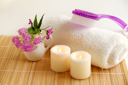 white  burn candles with lilac brush and flowers  