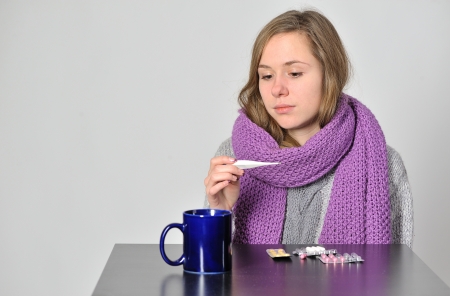 having flu young girl takes her  medicine for coldの写真素材