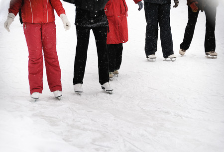 young  people  skating in winter parkの写真素材
