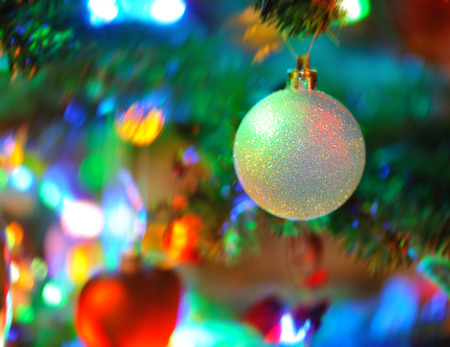 blur background  of inside decorated Christmas fir tree with colorful lightsの写真素材