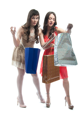 Two attractive girls with shopping bags isolated on white backgroundの写真素材