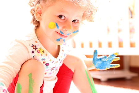 girl with paint hands isolated on white backgroundの写真素材