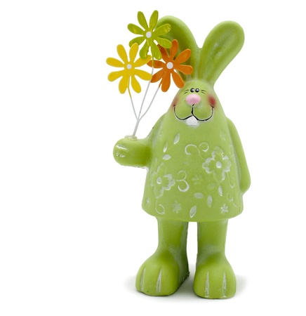 green rabbit toy with flowers over white backgroundの写真素材