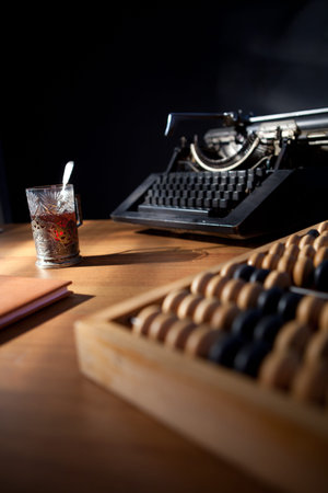a writer's desk with an old typewriter a notebook and pen and a cup of tea.