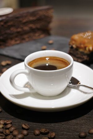 Cup of coffe with cake and beansの写真素材