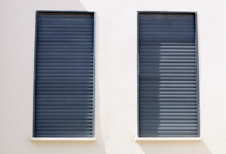 Windows of a house closed with shutters の写真素材