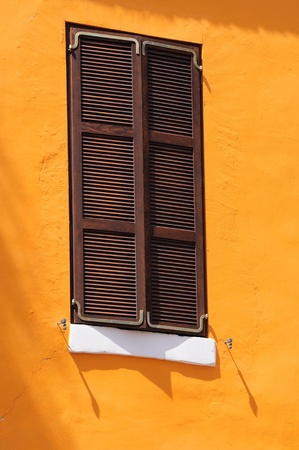 Window of a house closed with shutters の写真素材