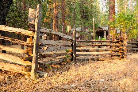 Wooden fence around house in forest of California.の写真素材