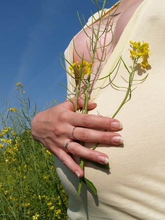 The pregnant woman in a rape fieldの写真素材