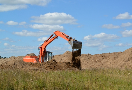 The excavator works at soil relocationの写真素材