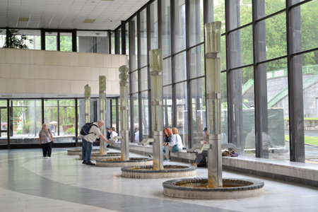 People drink water in gallery of mineral sources in Karlovy Vary, the Czech Republicのeditorial素材