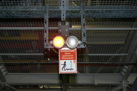 Precautionary inscription Attention! Shatl moves silently! in assembly shop of automobile plant