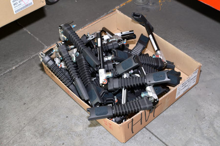 Locks for seat belts of the car lie in a box in assembly shop of automobile plant