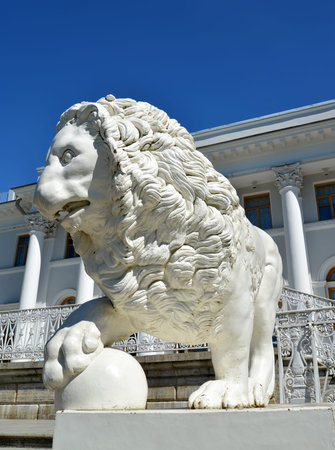 ST. PETERSBURG, RUSSIA - JULY 11, 2014: A white stone lion with a sphere against Yelagin Palaceのeditorial素材