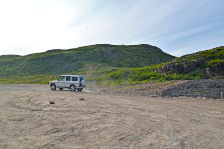 MURMANSK REGION, RUSSIA - JULY 19, 2015: The car goes on a dirt road of the Kola Peninsulaのeditorial素材