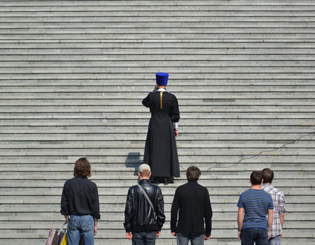 KALININGRAD, RUSSIA - APRIL 11, 2015: The orthodox priest says a prayer at steps of the Cathedral of...