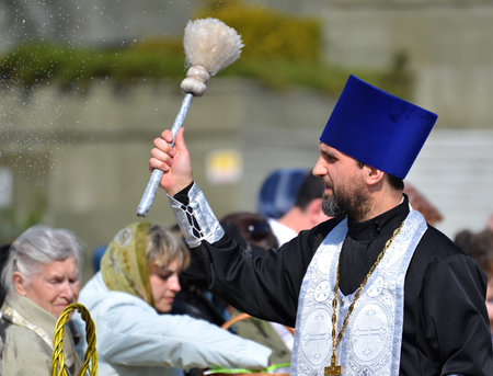 KALININGRAD, RUSSIA - APRIL 11, 2015:  The orthodox priest consecrates believers with the help an...