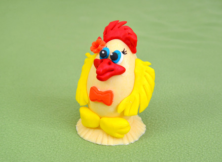 Easter chicken from white chocolate and culinary mastic on a green backgroundの写真素材