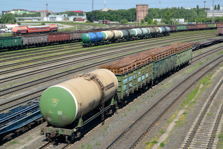 The tank and cars with wood stand Kaliningrad-sorting on the ways of a railway stationのeditorial素材
