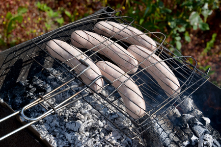 Frying of sausages on a brazierの写真素材