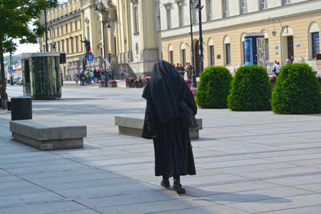 WARSAW, POLAND - AUGUST 23, 2014: The Catholic nun goes to a church of the Sacred Crossのeditorial素材