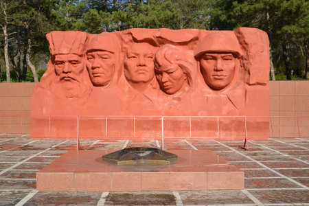 ELISTA, RUSSIA - APRIL 22, 2017: An eternal flame against the background of sculptural composition of the Memorial complex of heroes Civil and the Great Patriotic War of warsのeditorial素材