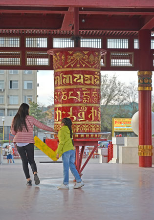 ELISTA, RUSSIA - APRIL 18, 2017: People rotate a prayer wheel with a mantra of Ohms of Manya Padme Hum. Pagoda of Seven Daysのeditorial素材