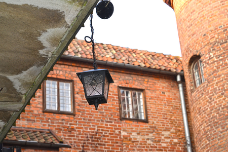 Decorative lamp against the background of a brick wall of the lock of the Teutonic Order. Poland, Kentshinの写真素材
