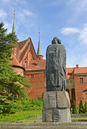 FROMBORK, POLAND - JULY 09, 2015: A monument to Nicolaus Copernicus against the background of a cathedral complexの写真素材