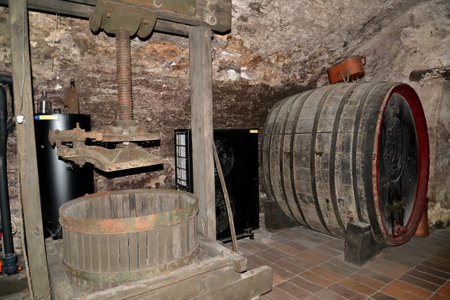 MELNIK, CZECH REPUBLIC - MAY 26, 2014: A screw press for a juice extraction from grapes and a flank for aging of wine. Wine vault of the museum of winemakingのeditorial素材