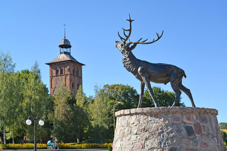 ZNAMENSK, RUSSIA - SEPTEMBER 15, 2016: Sculpture of a deer and Saint Yakov's Lutheran church. のeditorial素材