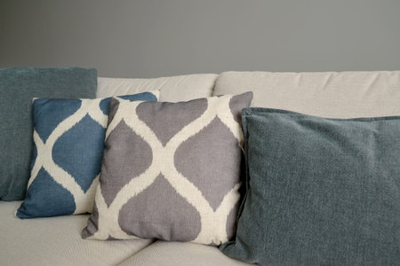 Throw pillows lie on a sofa. Living room interior fragment