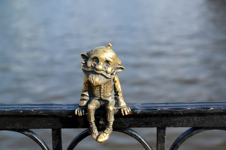 Miniature sculpture of Khomlinâ€™s grandfather sitting on the background of the river
